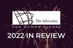[ai] The logo of The Advocates for Human Rights displayed against a background of fireworks. Below, the text reads '2022 IN REVIEW' in bold white letters.